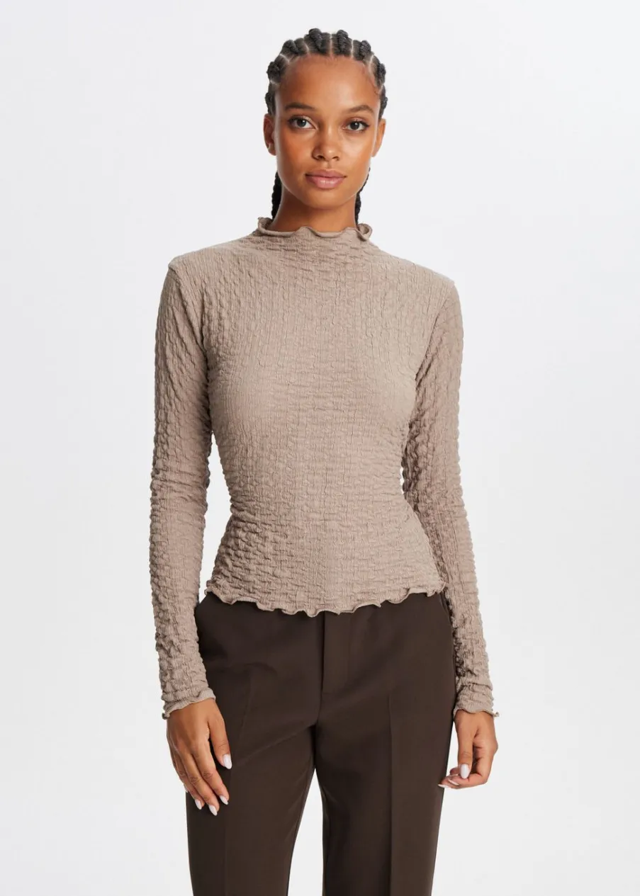 The Sting Top met strikdetail<DAMES Tops